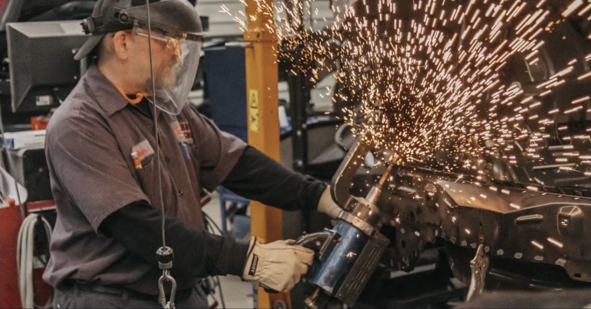 Welder fabricating metal in an industrial workshop